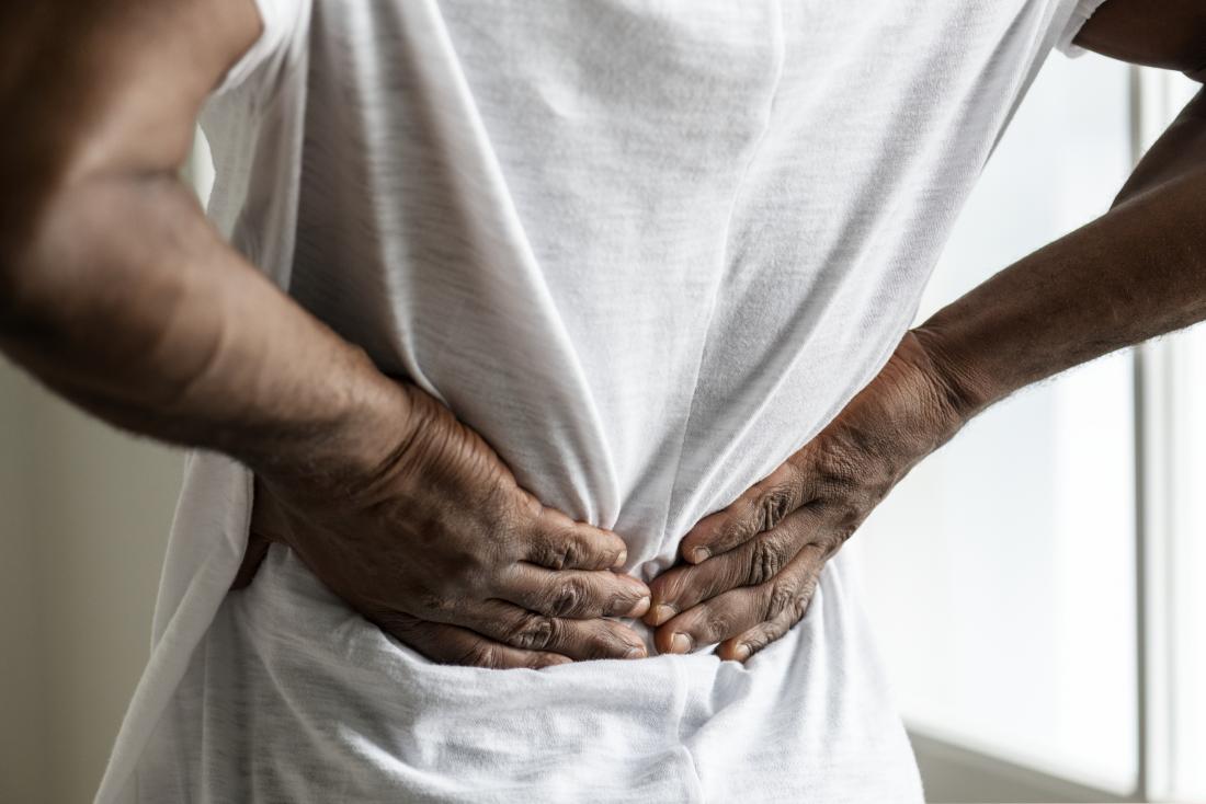 person-experiencing-lower-back-pain__PID:11c2a759-fe2c-4065-b3cc-0a6dc385a3d2